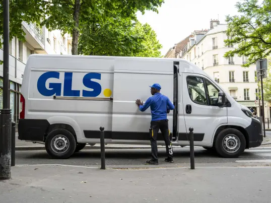 GLS driver unloading a parcel van.