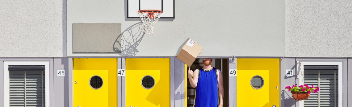 teenager smiling and opening a parcel