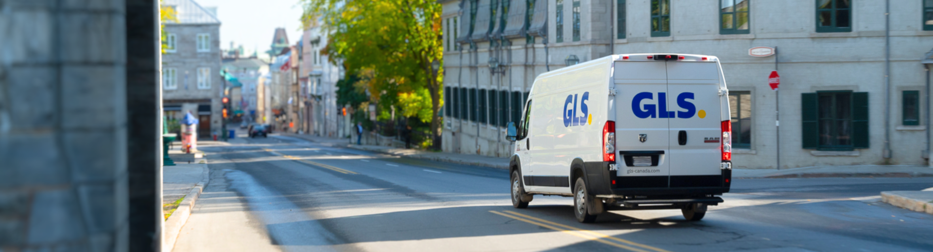 GLS parcel van driving along city streets in Old Quebec